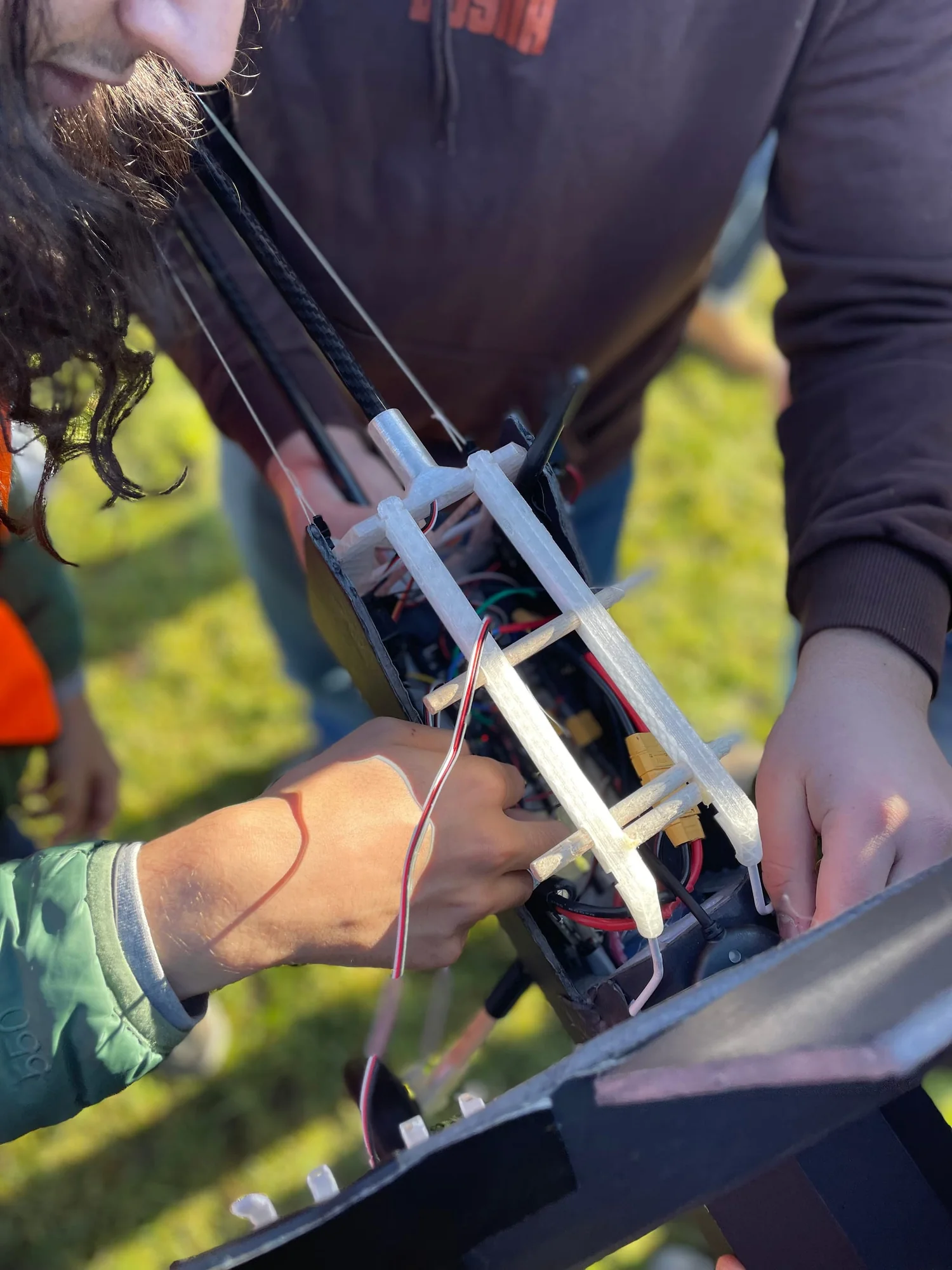 Hands working on the wiring inside an ICAV SPI airframe
